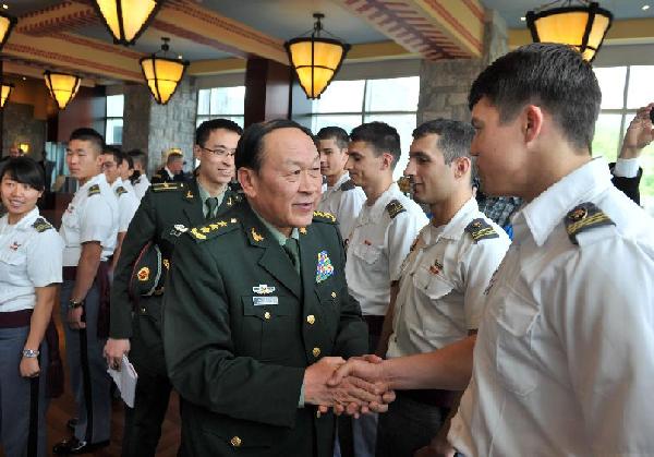 Visiting Chinese Defense Minister Liang Guanglie shakes hands with a cadet of the U.S. Military Academy at West Point in New York, the United States, on May 10, 2012 as he visits here Thursday. [Wang Lei/Xinhua] 