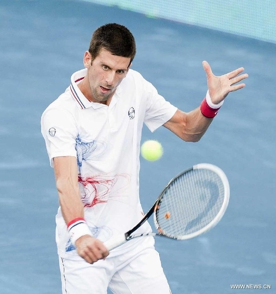 Novak Djokovic of Serbia returns a hit to his compatriot Janko Tipsarevic during their men's singles quarterfinal match at the Madrid Open tennis tournament, in Madrid, Spain, on May 11, 2012. Djokovic lost 0-2. (Xinhua/Xie Haining)
