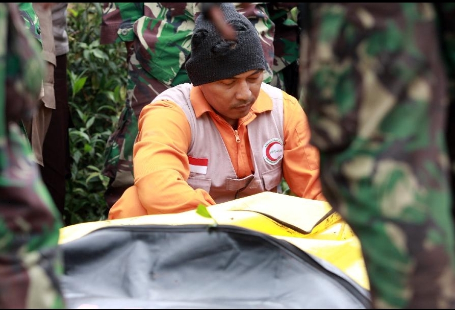 A rescuer encoffins the body of a plane crash victim in the Mount Salak in Bogor, West Java, Indonesia, May 11, 2012. Rescuers arrived at the site of the Russian-made Sukhoi super jet-100 crashed in Mount Salak on Friday. [Xinhua/Veri Sanovri]
