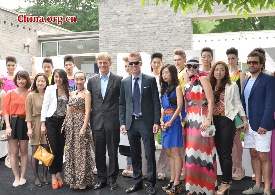 Danish Ambassador Friis Arne Petersen taking photos with models after a fashion show with a famous Danish fashion brand. The Embassy of Denmark in China organized an open-door event in Beijing on May 13, 2012, in order to provide visitors with a genuine taste of Danish culture. More than 2,000 people, including foreign dignitaries, 13 Danish brands and companies and about 1,500 micro-bloggers from weibo.com participated in the event. 