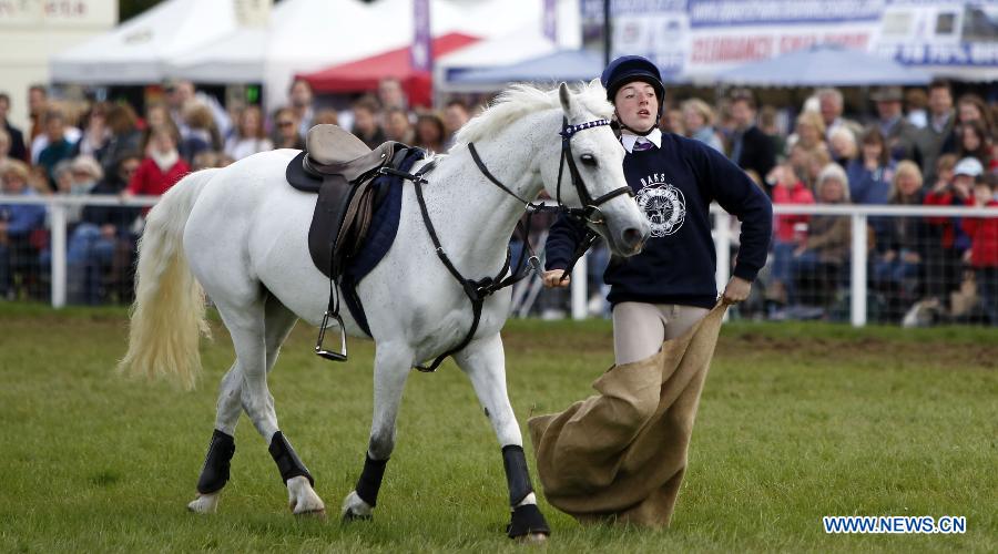 A youth from Scotland takes part in the pony competition of Windsor Horse Show in Windsor, Britain on May 12, 2012. (Xinhua/Wang Lili)