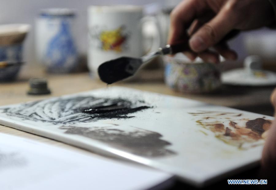 Liu Zhen mix the painting pigment in his studio at the Chengdexuan Porcelain Co.,Ltd, in Jingdezhen of east China's Jiangxi Province, March 8, 2012. [