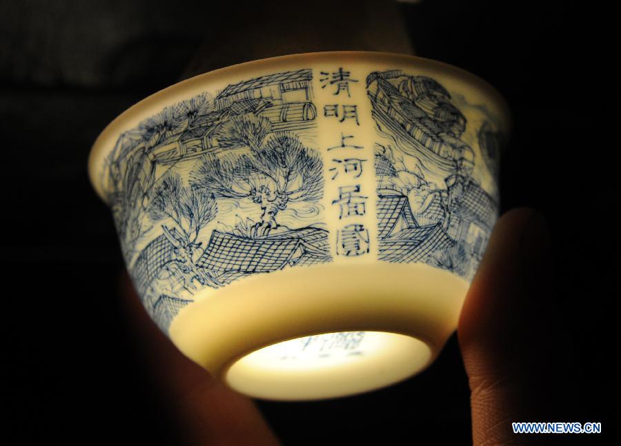 Photo taken on March 8, 2012 shows the tea cup 'Riverside Scene at the Qingming Festival' painted by Liu Zhen in Jingdezhen of east China's Jiangxi Province. [Xinhua/Zhou Ke]