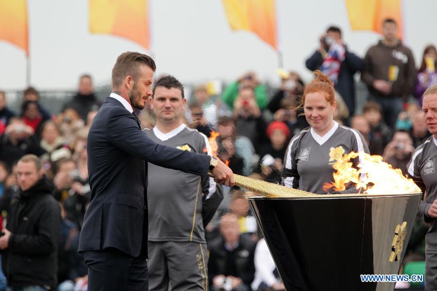 Beckham kicks off torch relay on British soil