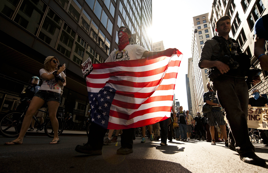 Demonstrators with Occupy Chicago march through the streets in Chicago, Illinois, May 18, 2012 ahead of the NATO 2012 Summit. 