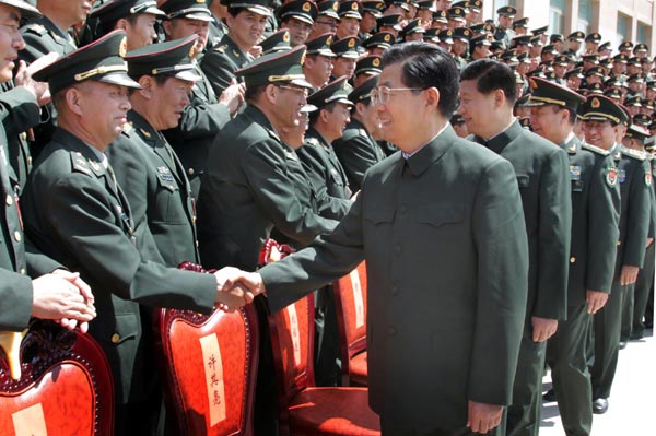 Chinese President Hu Jintao (R, front), who is also chairman of the Central Military Commission, meets with delegates to a conference of Communist Party of China (CPC) members in the Beijing Military Area Command in Beijing, capital of China, May 23, 2012. Chinese Vice-President Xi Jinping also attended the meeting. [Photo/Xinhua] 