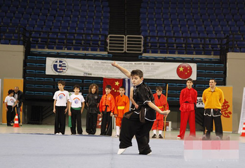 A boy plays kung fu during the competition.