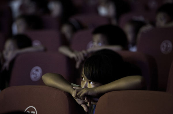 This 2011 photo shows pupils from a primary school in Longchuan county in Yunnan province watching a theater performance in Beijing. 