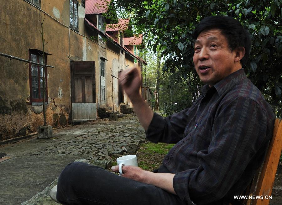 He Jiyuan, a retired villa keeper, sits in front of a villa built in 1896 on the Mogan Mountain in Deqing County, east China's Zhejiang Province. Foreigners began to build villas on the Mogan Mountain since 1896 because of its coolness and quietness. 