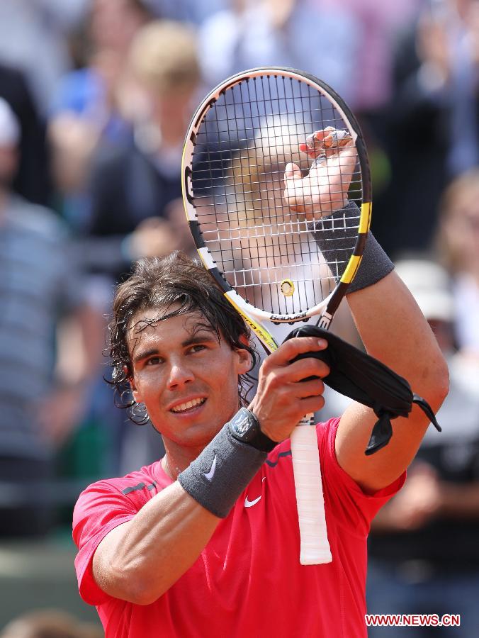 Rafael Nadal of Spain celebrates after winning the men's singles second round match against Denis Istomin of Uzbekistan at the French Open tennis tournament in Paris, May 31, 2012. Nadal won 3-0.