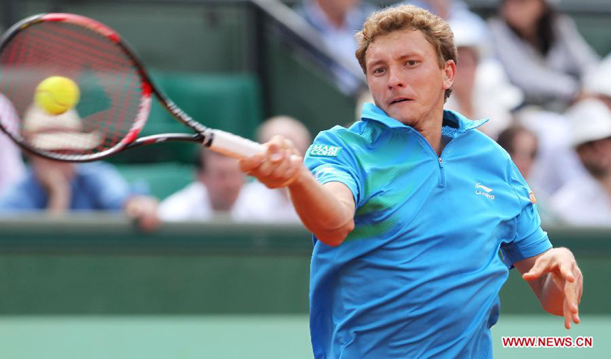 Denis Istomin of Uzbekistan returns the ball during the men's singles second round match against Rafael Nadal of Spain at the French Open tennis tournament in Paris, May 31, 2012. Nadal won 3-0.