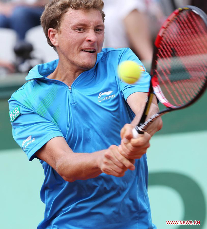 Denis Istomin of Uzbekistan returns the ball during the men's singles second round match against Rafael Nadal of Spain at the French Open tennis tournament in Paris, May 31, 2012. Nadal won 3-0.