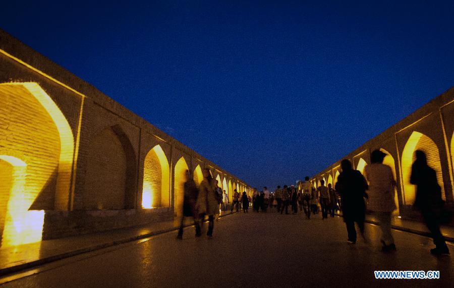 People walk on 'Si-o-Seh Pol' bridge in Isfahan, central Iran, May 31, 2012. Isfahan, the third largest city in Iran, is a world famous historical city well-known for ancient architectures, fine carpets, silver filigree and handicrafts. (Xinhua/Ahmad Halabisaz)