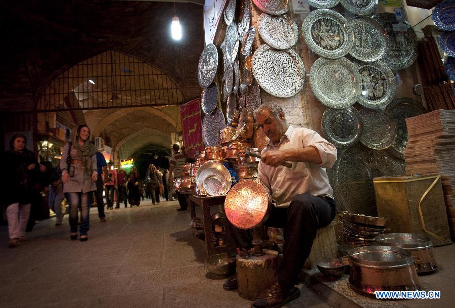 A man makes handicraft at an old bazaar in Isfahan, central Iran, May 31, 2012. Isfahan, the third largest city in Iran, is a world famous historical city well-known for ancient architectures, fine carpets, silver filigree and handicrafts. (Xinhua/Ahmad Halabisaz) 