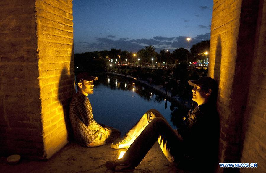 Youths enjoy themselves as they sit on 'Si-o-Seh Pol' bridge in Isfahan, central Iran, May 31, 2012. Isfahan, the third largest city in Iran, is a world famous historical city well-known for ancient architectures, fine carpets, silver filigree and handicrafts. (Xinhua/Ahmad Halabisaz) 