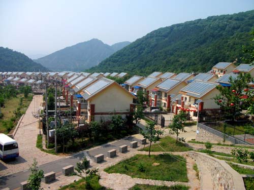 Solar panels shine in the sun at the new village of Guajiayu.