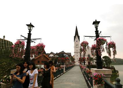 Women walk at the Chinese replica of Austria's UNESCO heritage site, Hallstatt Village in China's southern city of Huizhou in Guangdong Province June 2, 2012.