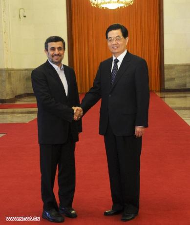 Chinese President Hu Jintao (R) shakes hands with Iranian President Mahmoud Ahmadinejad during a welcoming ceremony for Ahmadinejad at the Great Hall of the People in Beijing, capital of China, June 8, 2012. Ahmadinejad came to pay a visit to China and attend the 12th Meeting of the Council of Heads of Member States of the Shanghai Cooperation Organization (SCO). [Rao Aimin/Xinhua]