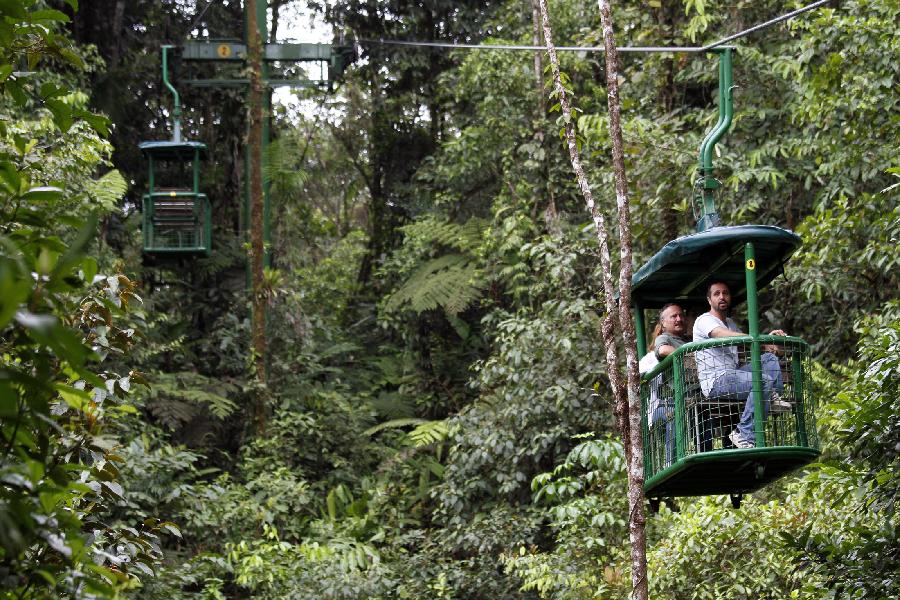 A group of tourists enjoy a cableway trip in the tropical forest of the Braulio Carrillo National Park, 50 kilometers east of San Jose, capital of Costa Rica, June 4, 2012.