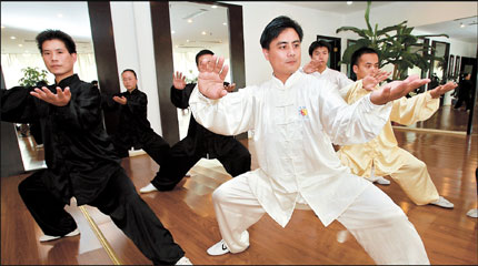 Master Huang Zhongda (in white) guides his students in a training session of tai chi, a kind of Chinese martial arts, in Shanghai. 