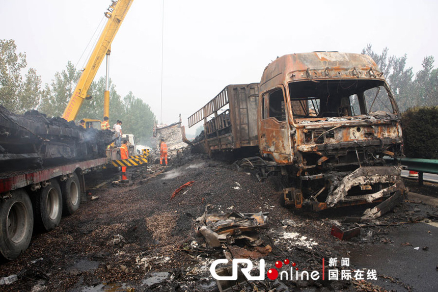 Rescuers clean vehicle debris on the accident scene of the rear-end collisions at the Mengcheng section of the Nanjing-Luoyang Expressway near Bozhou, east China's Anhui Province, June 10, 2012. Eleven people were killed and another 59 injured in several rear-end collisions on the section of expressway on Saturday night, rescuers said Sunday.