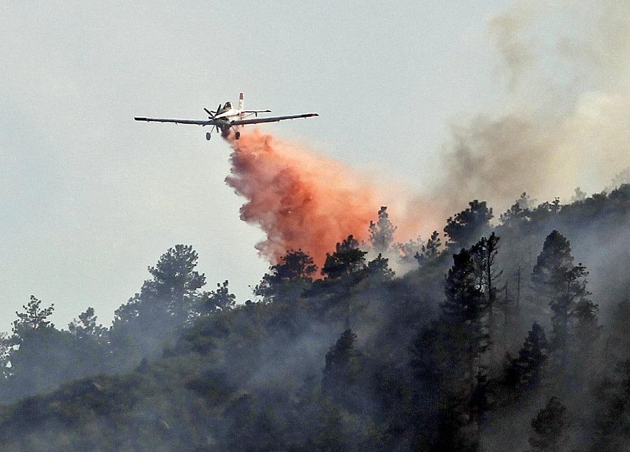 A slurry bomber drops a load of retardant on the High Park wildfire near Fort Collins, Colo. , on Monday, June 11, 2012. 