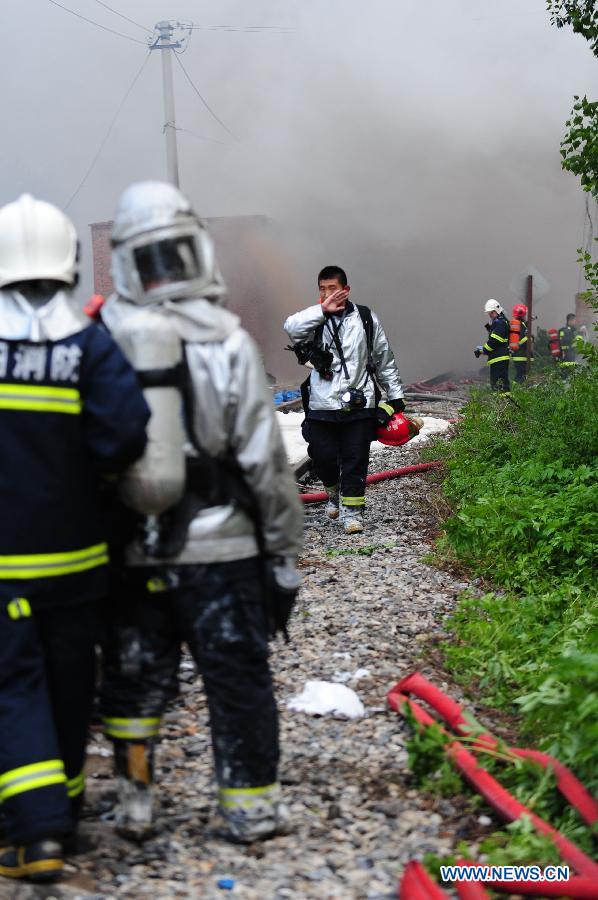 Firemen work at the spot of accident in Wangjiao chemical plant in Shenyang, capital of northeast China's Liaoning Province, June 12, 2012. A depot of the factory exploded at 4:30 p.m. in the Yuhong district, shattering windows at a distance of 200 meters and resulting in a massive cloud of smoke, witnesses said. 