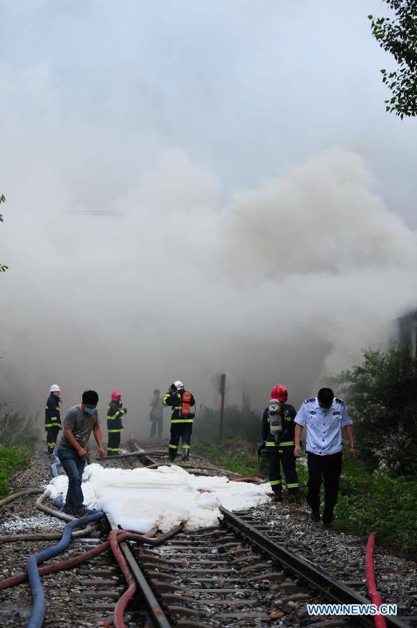 Firemen work at the spot of accident in Wangjiao chemical plant in Shenyang, capital of northeast China's Liaoning Province, June 12, 2012. A depot of the factory exploded at 4:30 p.m. in the Yuhong district, shattering windows at a distance of 200 meters and resulting in a massive cloud of smoke, witnesses said. 