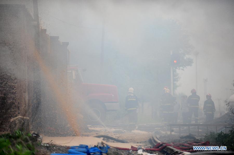 Firemen work at the spot of accident in Wangjiao chemical plant in Shenyang, capital of northeast China's Liaoning Province, June 12, 2012. A depot of the factory exploded at 4:30 p.m. in the Yuhong district, shattering windows at a distance of 200 meters and resulting in a massive cloud of smoke, witnesses said. 