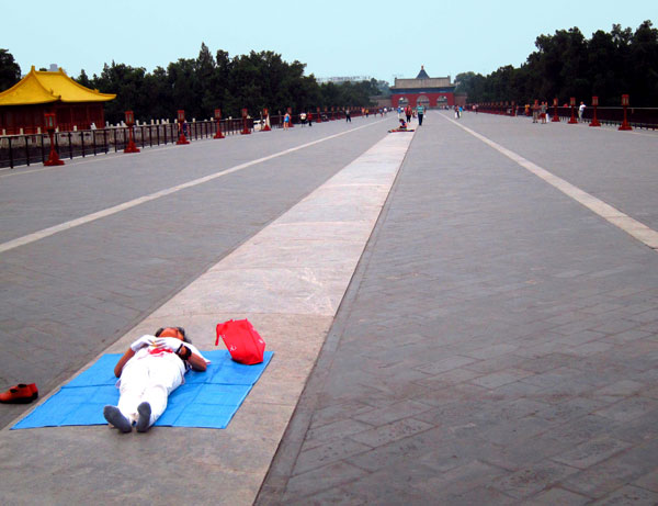 A woman stretches out on the Temple of Heaven's Danbei Bridge.