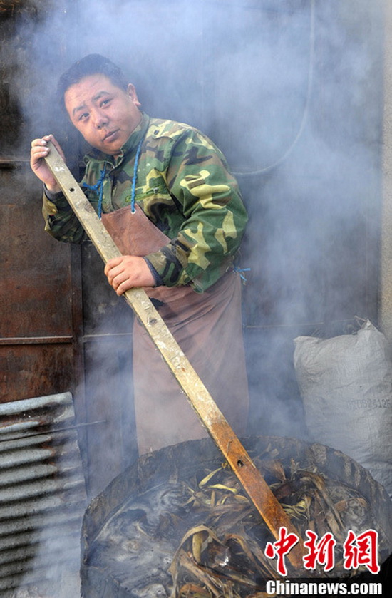 A worker is boiling peeled raw materials. (CNS Photo / Li Lin)