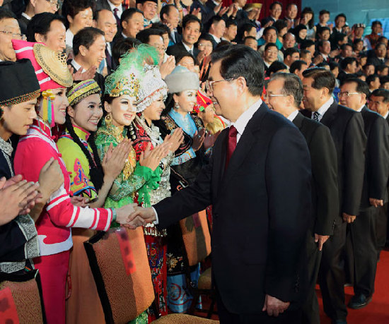President Hu Jintao and other senior leaders shake hands with performers at the opening ceremony for the fourth Minorities Art Festival of China in Beijing on June 12, 2012. [ Photo / Xinhua ]