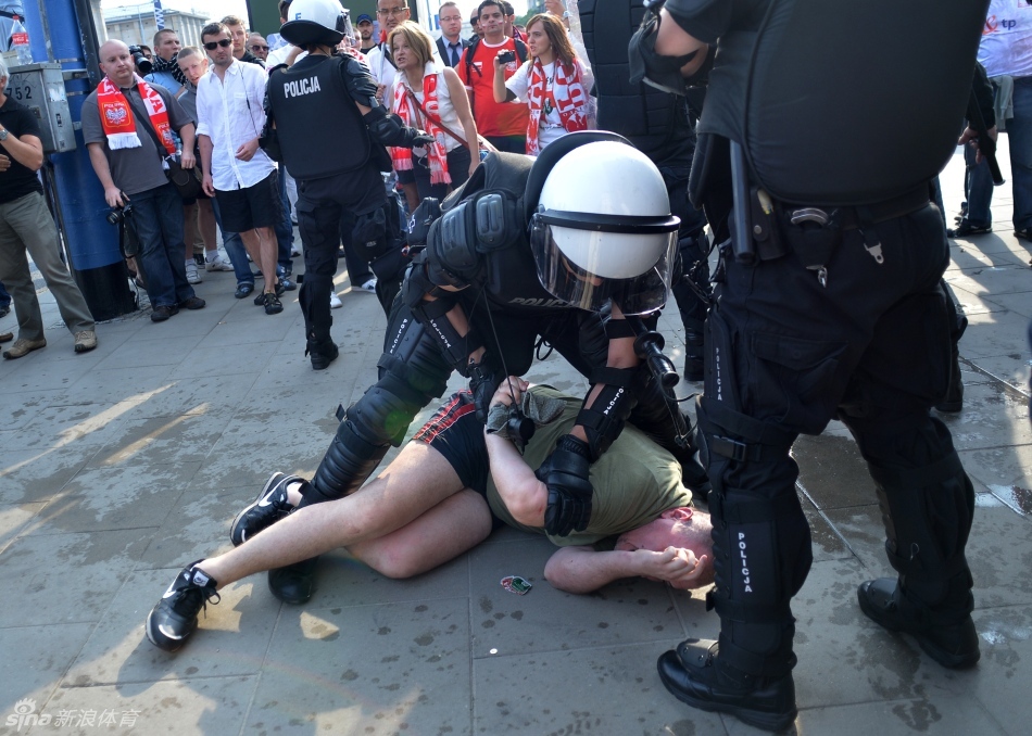 Polish riot police detain a fan. 