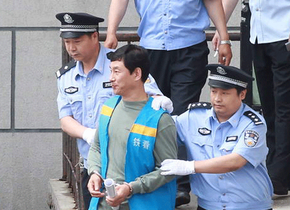 Nan Yong is taken to the court by police on Wednesday. [Photo/CFP]