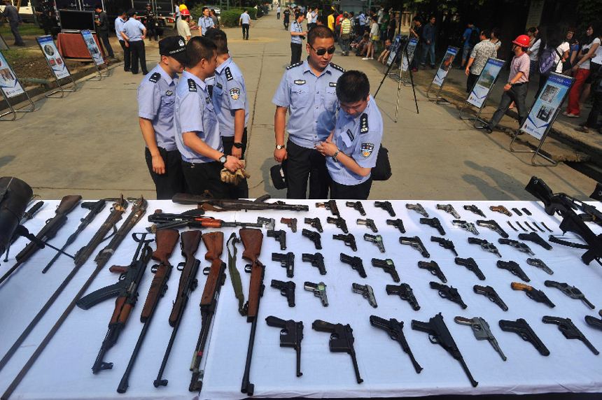 Details of confiscated illegal guns are displayed in Sichuani Province, June 12, 2012. During a unified operation, police force destroyed more than 100,000 confiscated illegal guns and over 250 tons of explosives in 150 cities across China on Tuesday. [Xinhua] 