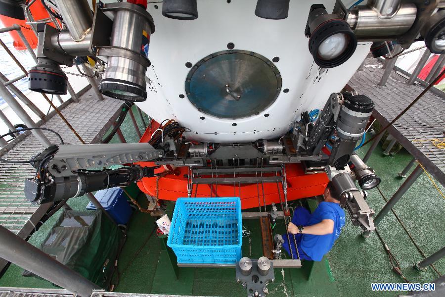 A staff member adjusts devices on the deep-sea submersible, Jiaolong, aboard Xiangyanghong 09, the submersible's oceanographic mother ship, June 14, 2012