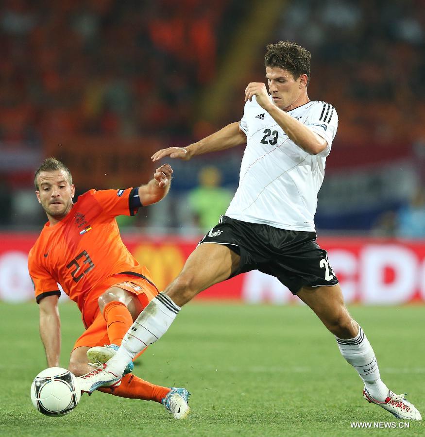 Mario Gomez (R) of Germany vies with Rafael van der Vaart of Netherlands during their Group B 2nd round match at the Euro 2012 football championships in Kharkiv, Ukraine, June 13, 2012. Germany won 2-1. (Xinhua/Meng Yongmin) 