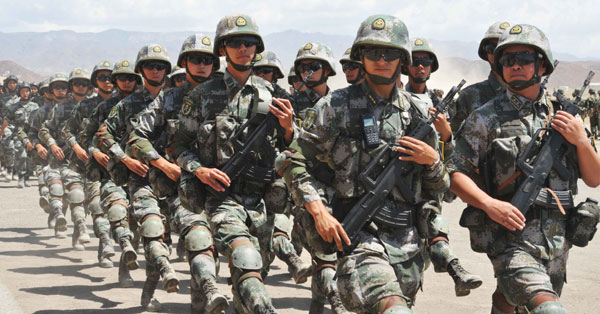 Armored cars and Chinese soldiers participate in the Peace Mission 2012 anti-terror drill held by Shanghai Cooperation Organization countries in Tajikistan on Thursday. The drill involved about 2,000 military personnel from China, Kazakhstan, Kyrgyzstan, Russia and Tajikistan. [Li Jing/China Daily]