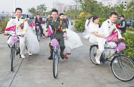 Twenty six newly wed couples held a group wedding on the first day of 2012 in Zhanjiang, Guangdong province, aiming to raise the public awareness of environmental protection and a low-carbon lifestyle. [China Daily] 