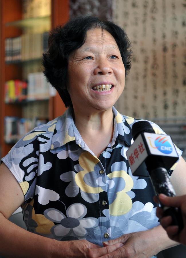 Wang Xiuju, a physics teacher of Liu Yang, one of the three taikonauts who will be carried by the Shenzhou-9 spaceship for China's first manned space docking mission with the orbiting Tiangong-1 space lab module, is interviewed in Zhengzhou, capital of central China's Henan Province, June 13, 2012. Zhengzhou is the hometown of Liu Yang. (Xinhua/Li Bo) 