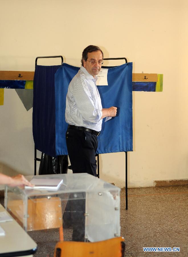 Antonis Samaras, president of the conservative party New Democracy, prepares to cast his vote in the town of Pylos, southern Greece, June 17, 2012. Greek political leaders cast their ballots on Sunday in crucial general elections and expressed optimism over the results of the polls that could determine Greece's economic future and membership in the European single currency zone. 