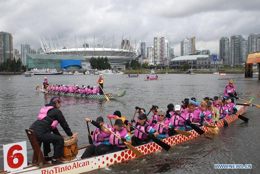 Rowers participate in the 24th Annual Rio Tinto Alcan Dragon Boat Festival and Race at False Creek in Vancouver, Canada, June 17, 2012. 