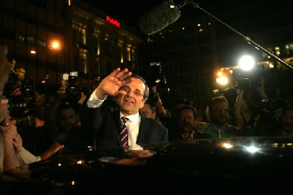 New Democracy party leader Antonis Samaras waves at supporters after his party came first in the national Greek's election, in central Athens, on June 17, 2012. The pro-bailout conservative New Democracy party beat the anti-bailout leftist Syriza party in Greece's crucial election on Sunday, according to the updated exit poll released nearly two hours after all polling stations were closed. [Marios Lolos/Xinhua]