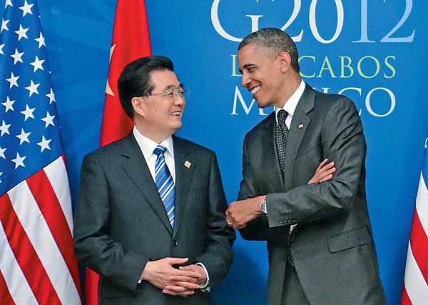 President Hu Jintao and his US counterpart Barack Obama share a light moment during the G20 Summit in Los Cabos, Mexico, on Tuesday. [Lan Hongguang/Xinhua]