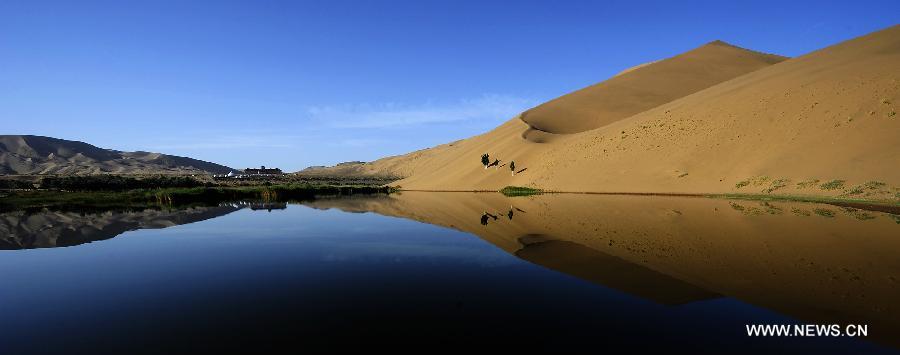 Photo taken on June 19, 2012 shows scenery of the Badain Jaran Desert in Alashan of north China's Inner Mongolia Autonomous Region. The Badian Jaran Desert is 47,000 square km and sparsely populated. It is famous for having the tallest stationary sand dunes in the world. Some dunes reach a height of 500 meters. But it also features spring-fed lakes that lie between the dunes. (Xinhua/Wang Peng) 