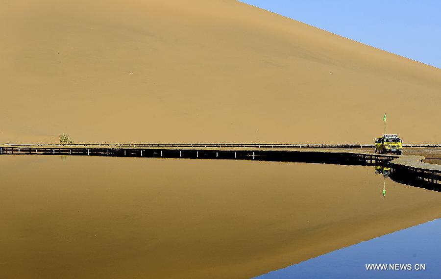 Photo taken on June 19, 2012 shows scenery of the Badain Jaran Desert in Alashan of north China's Inner Mongolia Autonomous Region. The Badian Jaran Desert is 47,000 square km and sparsely populated. It is famous for having the tallest stationary sand dunes in the world. Some dunes reach a height of 500 meters. But it also features spring-fed lakes that lie between the dunes. (Xinhua/Wang Peng) 