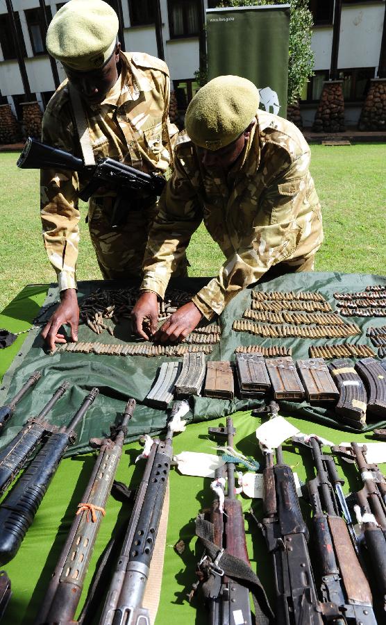 Soldiers display the ammunition seized from poachers in Nairobi, Kenya, June 22, 2012. Since the beginning of the year, Kenya Wildlife Service have arrested and taken to court 1179 suspects and charged them with various wildlife-related offences. From January to May this year, a total of 133 elephants and 11 rhinos have been killed by poaching. [Xinhua]