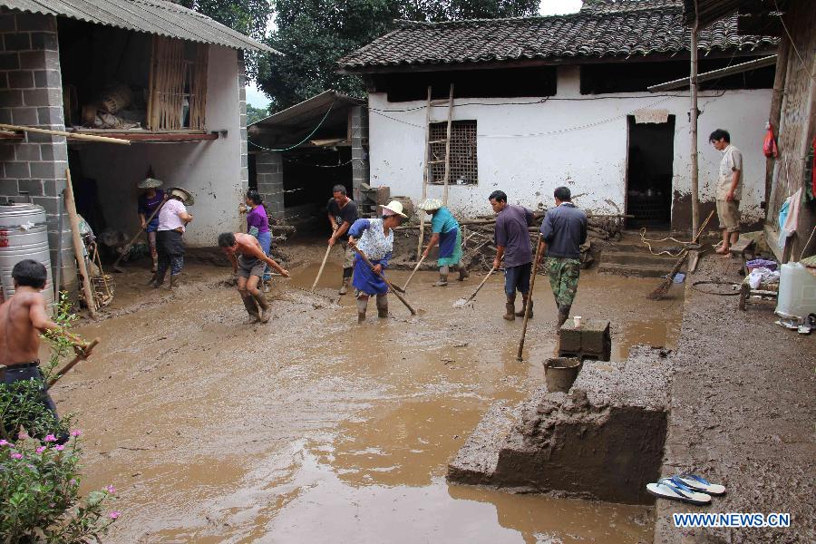 Villagers clear silt in Fanmeng Village of Yingjiang County, southwest China's Yunnan Province, June 24, 2012