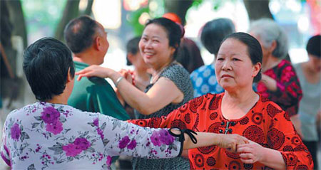 Retired residents of Huaying city, Sichuan province, dance in a park on June 2. More than 10,000 city retirees attend dance events held by communities every day.