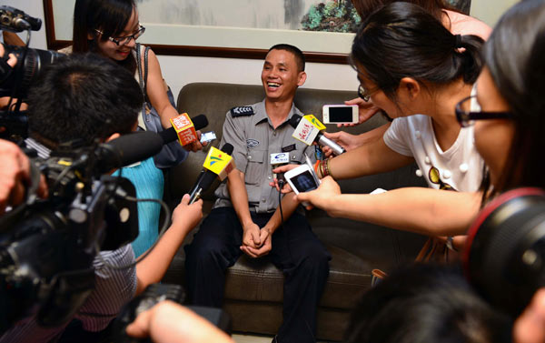 Huang Zhaojing is interviewed by media in Guangzhou, Guangdong province, on Sunday. [ Photo / China Daily ]